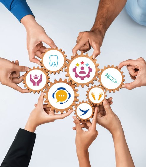 Diverse Hands Collaborating with Gears and Icons Symbolizing Teamwork, Technology, and Business Strategy in a Modern Office Context. Amity